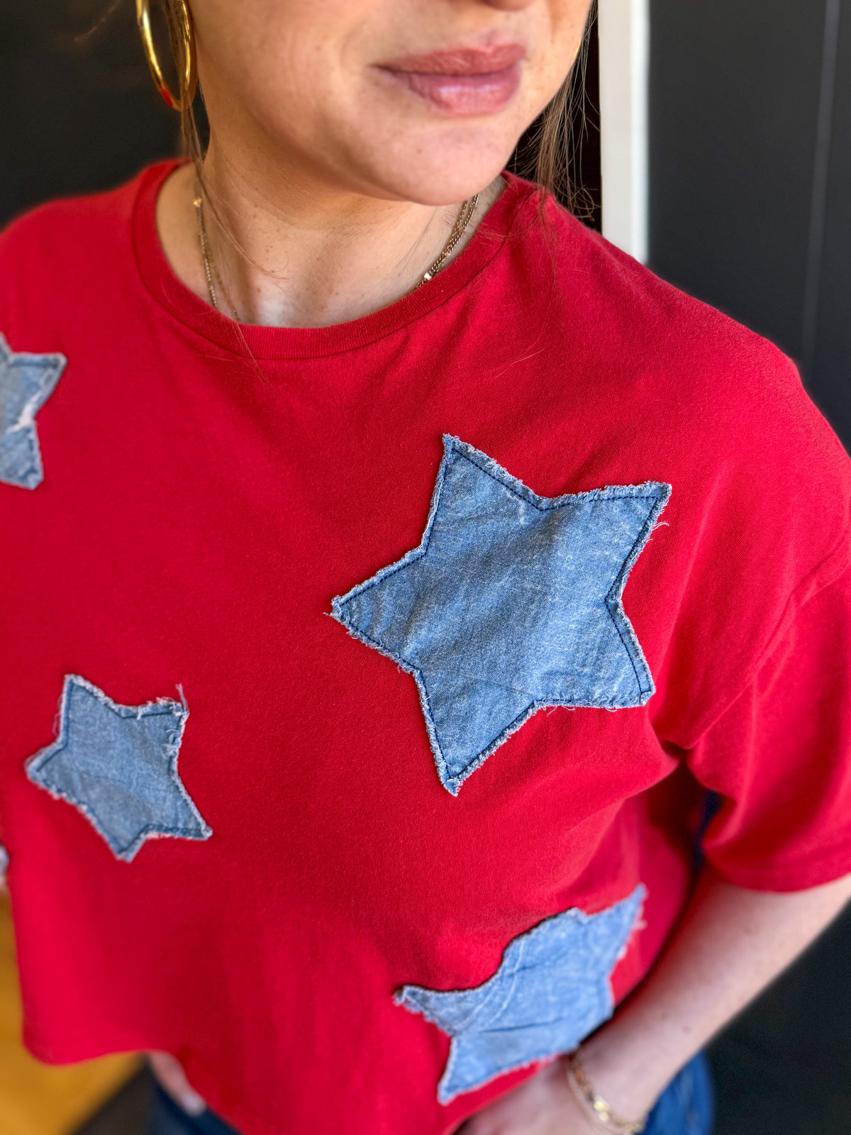 Red shirt with blue star patterns worn by a person.